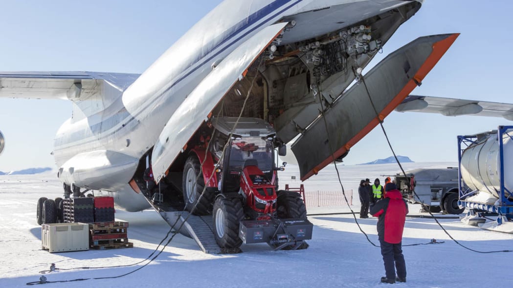 tractor girl's Massey Ferguson 5610 unloading from airplane on antarctica