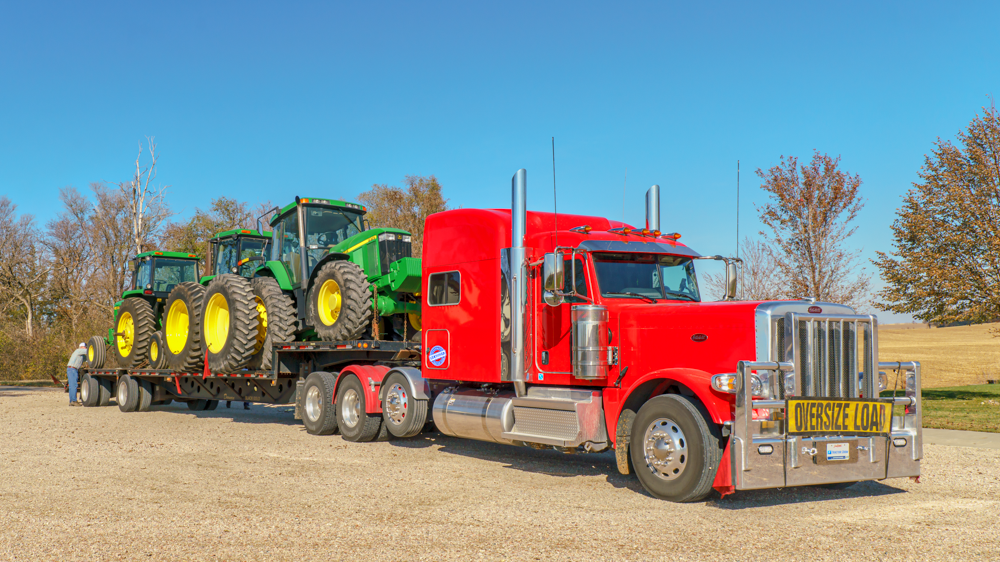 Peterbilt 389 loaded with 3 John Deere tractors